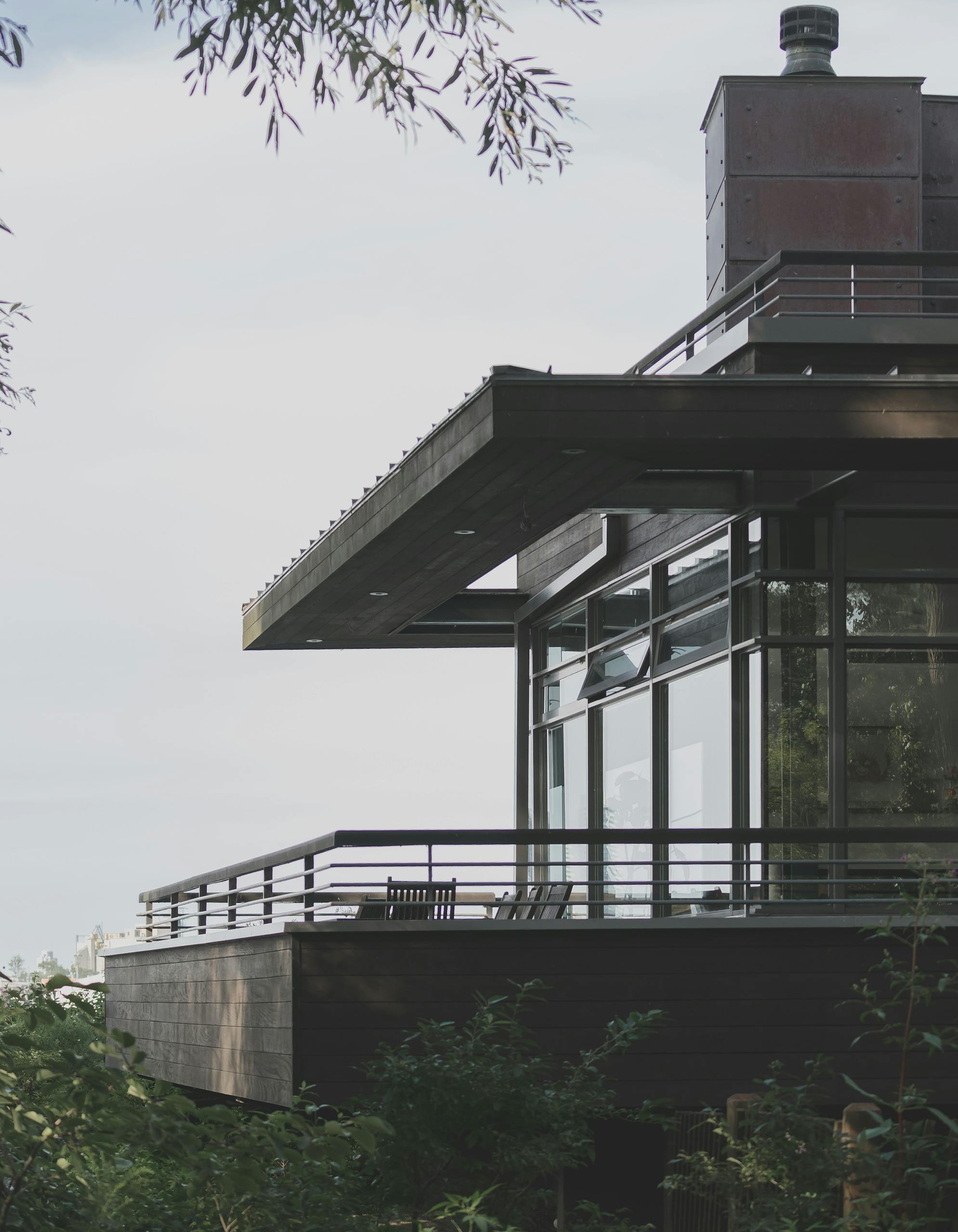 A contemporary house with glass windows and balcony design located in Toronto, Canada.